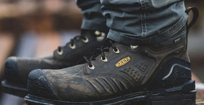 Close-up of rugged black work boots on wood.