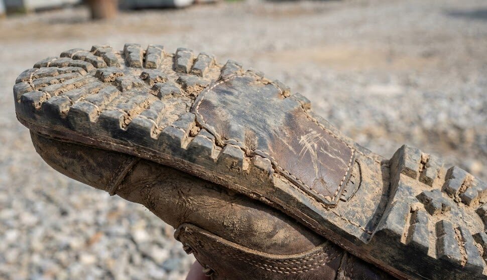 Close-up of a muddy boot sole.