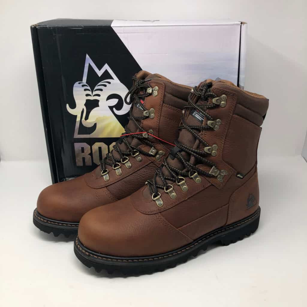 Brown hiking boots with sturdy soles and box.