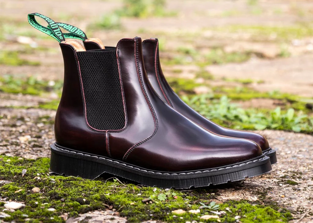 Stylish brown Chelsea boots on outdoor surface.