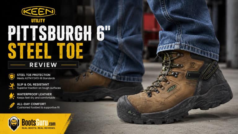 Close-up of KEEN Utility Pittsburgh 6-inch steel toe work boots worn by a person standing on a workshop floor, highlighting durability and safety features.