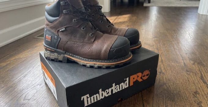 Pair of brown Timberland PRO Boondock 6 inch composite toe work boots standing on a Timberland PRO box
