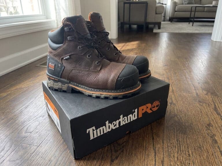 Pair of brown Timberland PRO Boondock 6 inch composite toe work boots standing on a Timberland PRO box