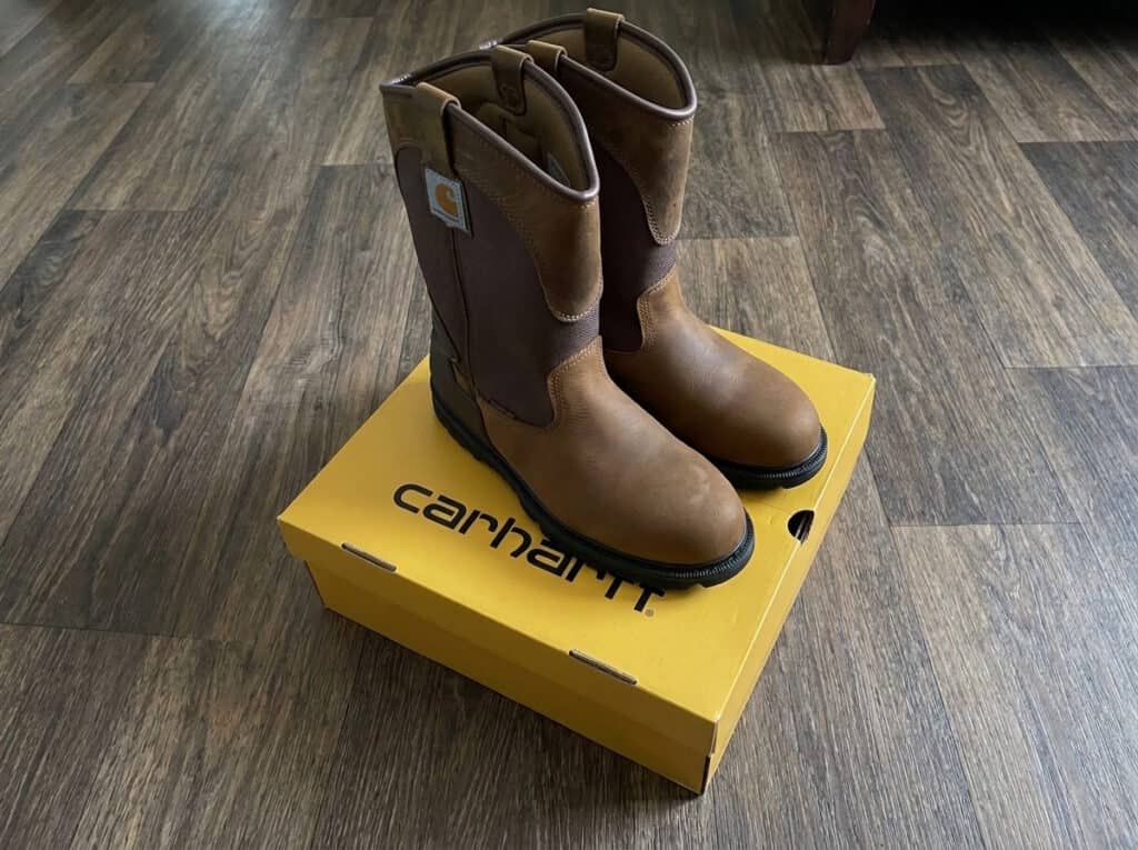 Carhartt Heritage WP 11 inch soft toe Wellington boots in Bison Brown standing on a yellow Carhartt box