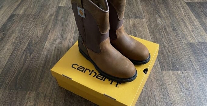 Carhartt Heritage WP 11 inch soft toe Wellington boots in Bison Brown standing on a yellow Carhartt box