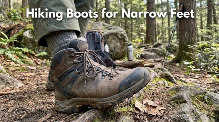 Close-up of a hiking boot on a trail in a forest, highlighting narrow fit and sturdy design for hiking enthusiasts.